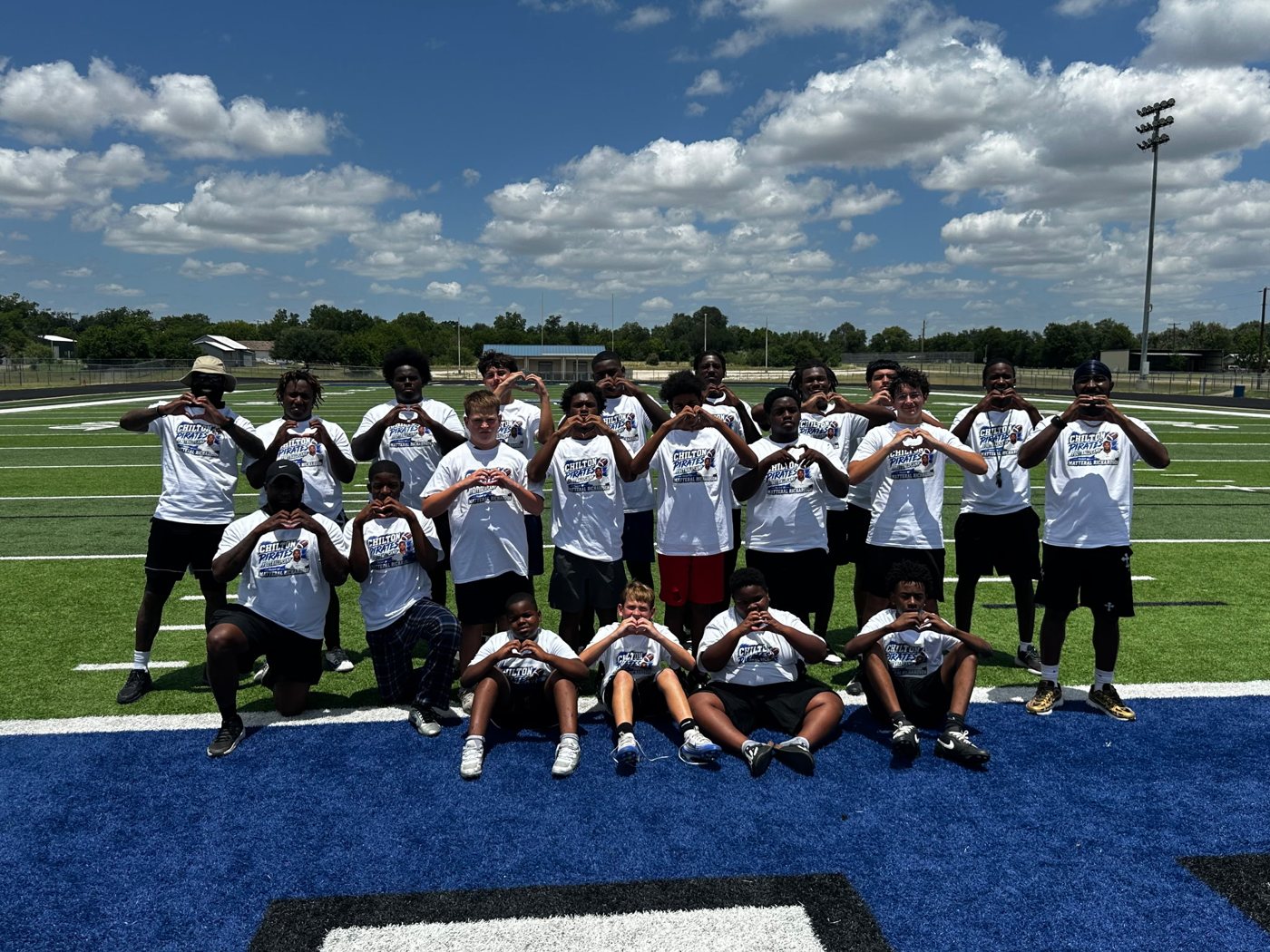 All Chilton Pirates Football Camp participants making heart hands