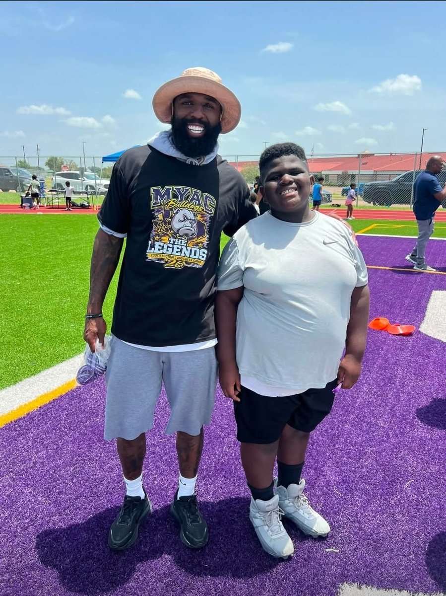 Matterial Richardson with a Legends camp participant on the purple field